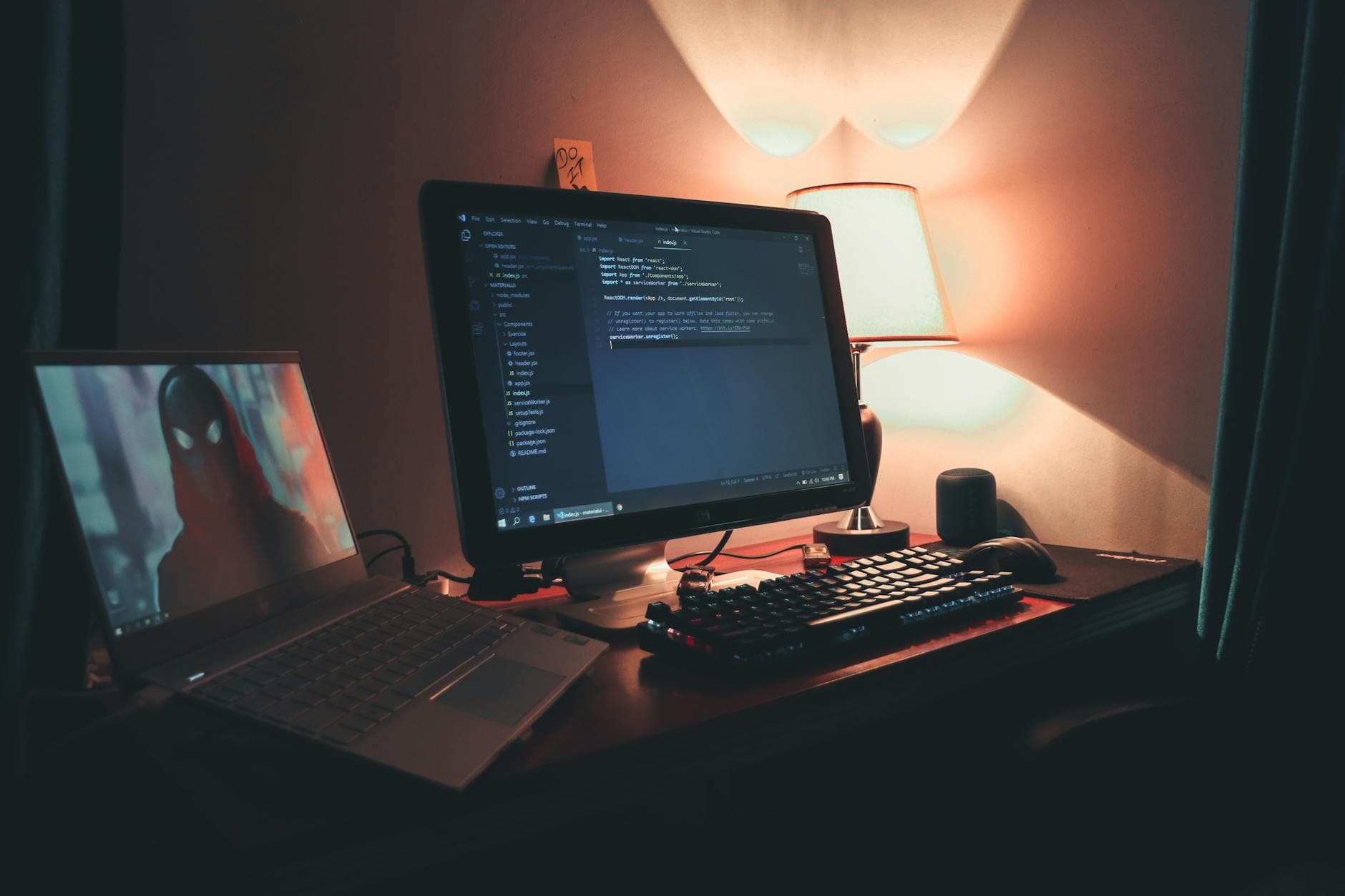 A laptop screen glowing in a low-light workspace