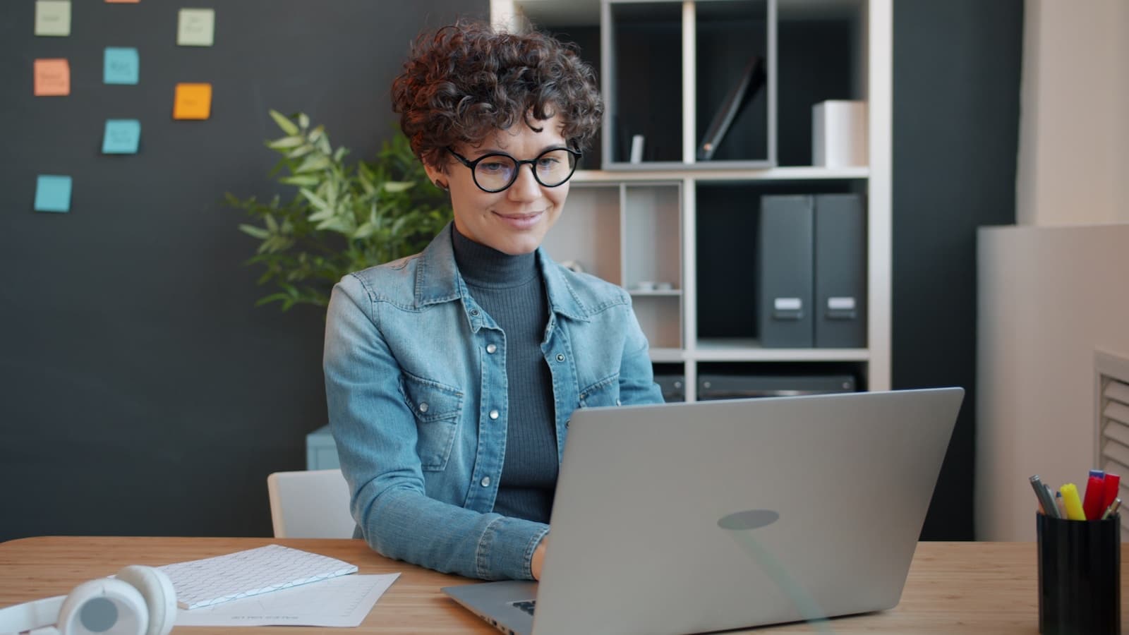 A person working on a laptop in a clean modern workspace