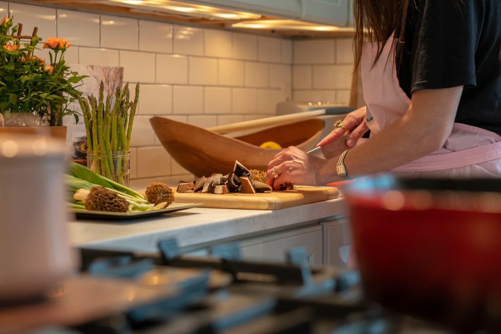 A person preparing fresh vegetables in a bright home kitchen
