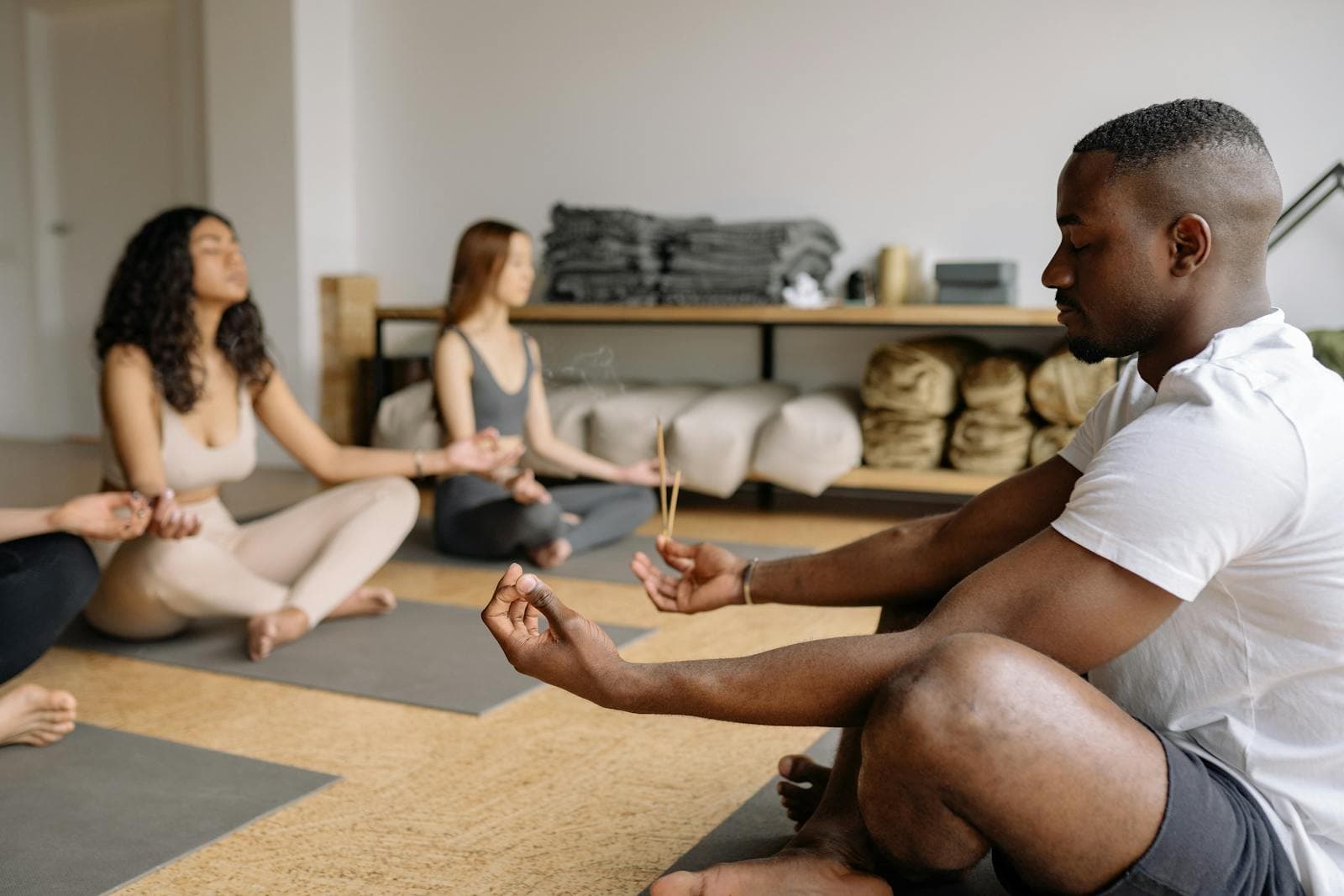 A diverse group meditating mindfully in a calm indoor setting