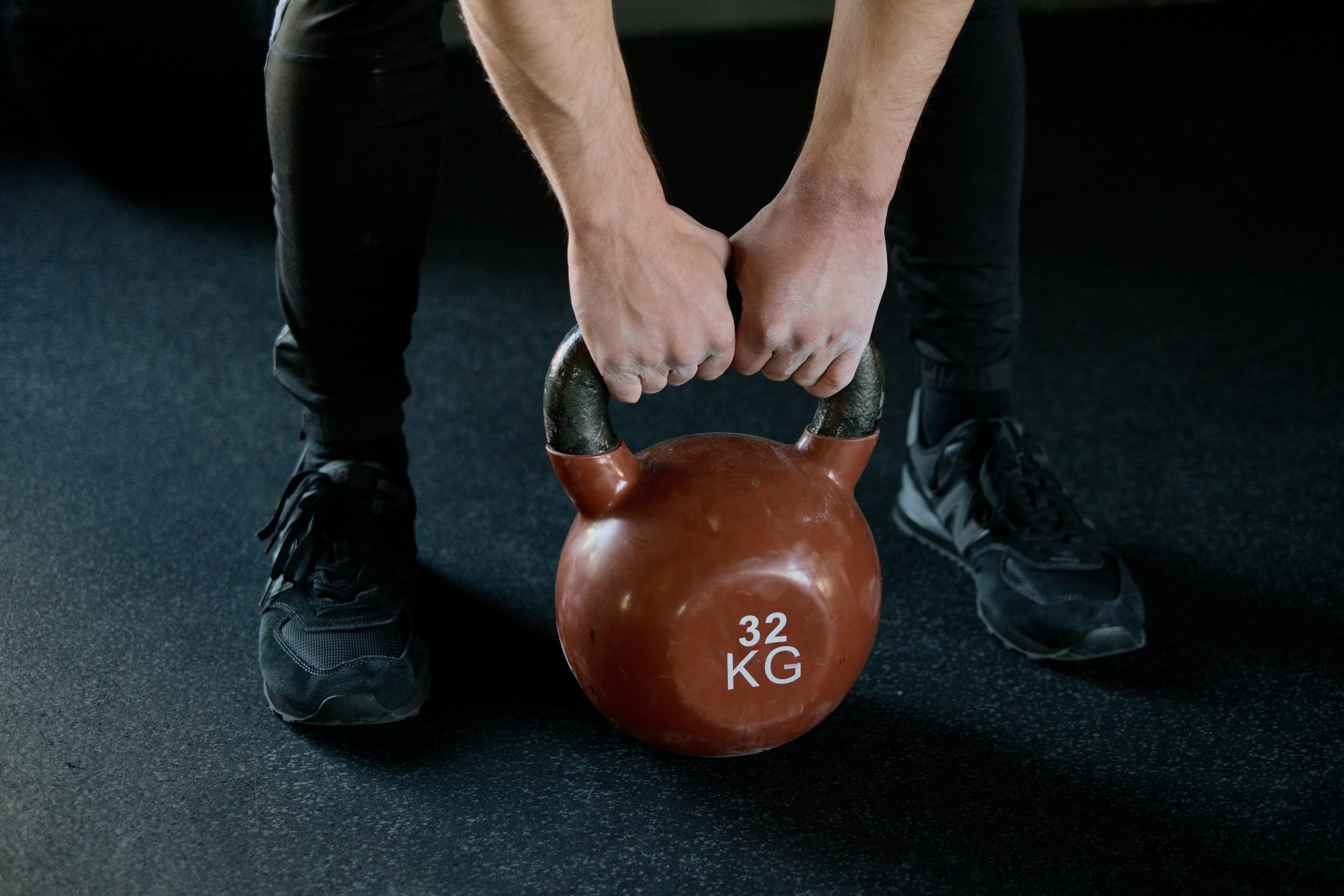 A person doing a kettlebell rep at home