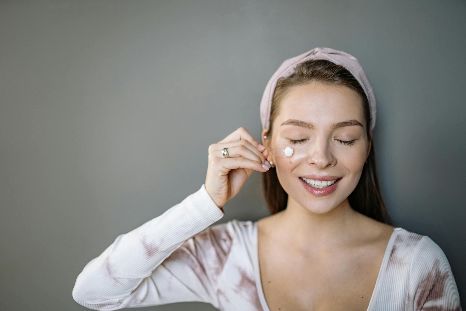 A close-up of an eye cream applicator with product on the tip