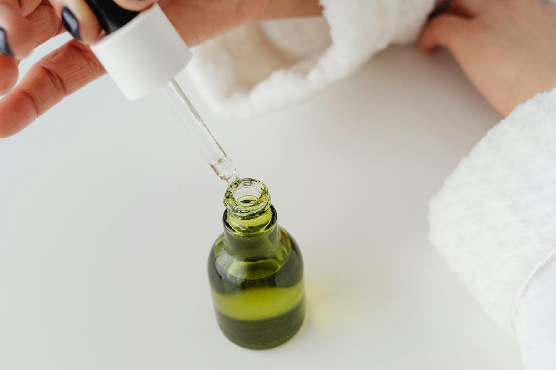 A skincare serum dropper bottle styled in a flat-lay
