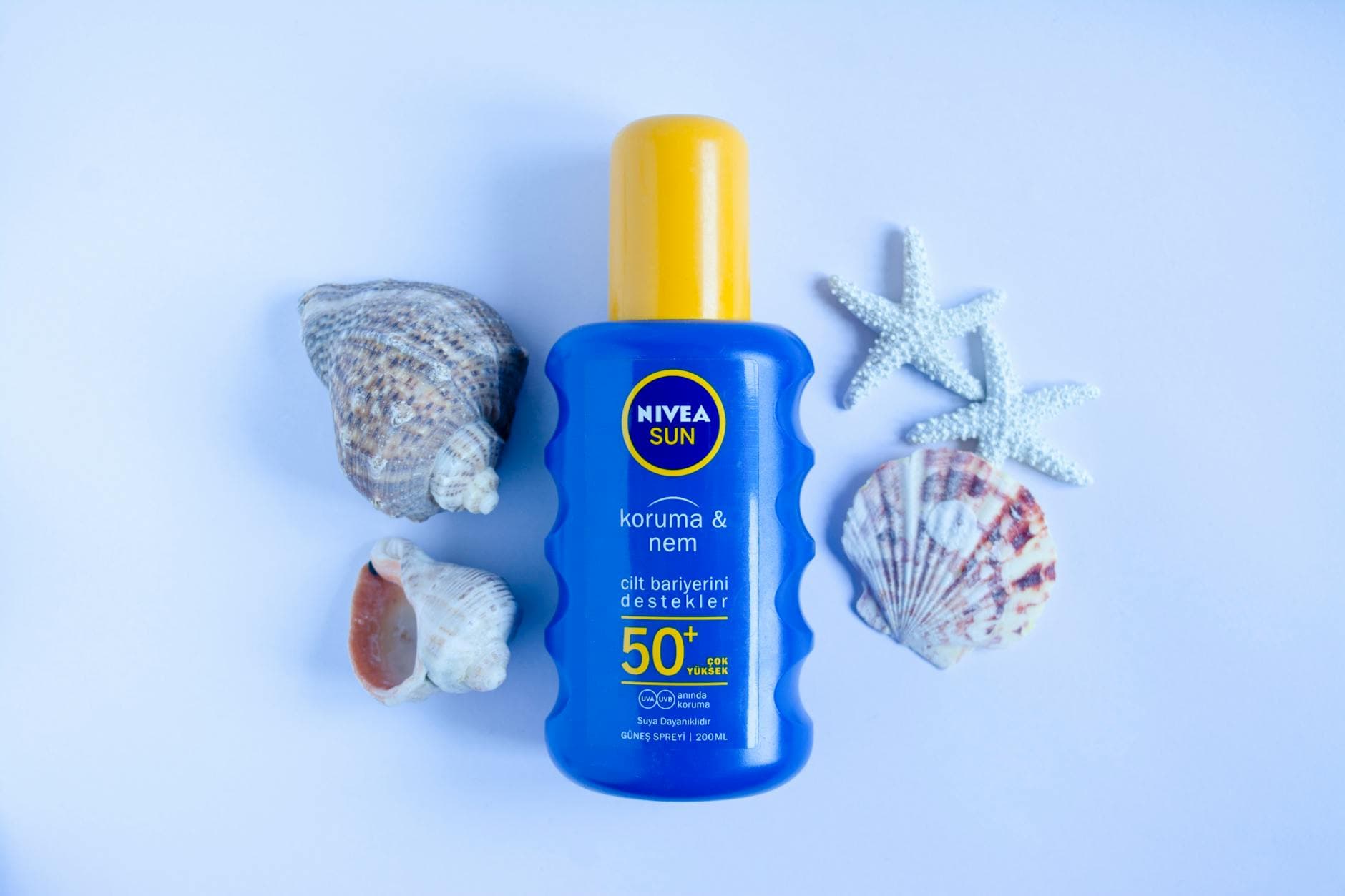 An SPF sunscreen bottle in soft natural light
