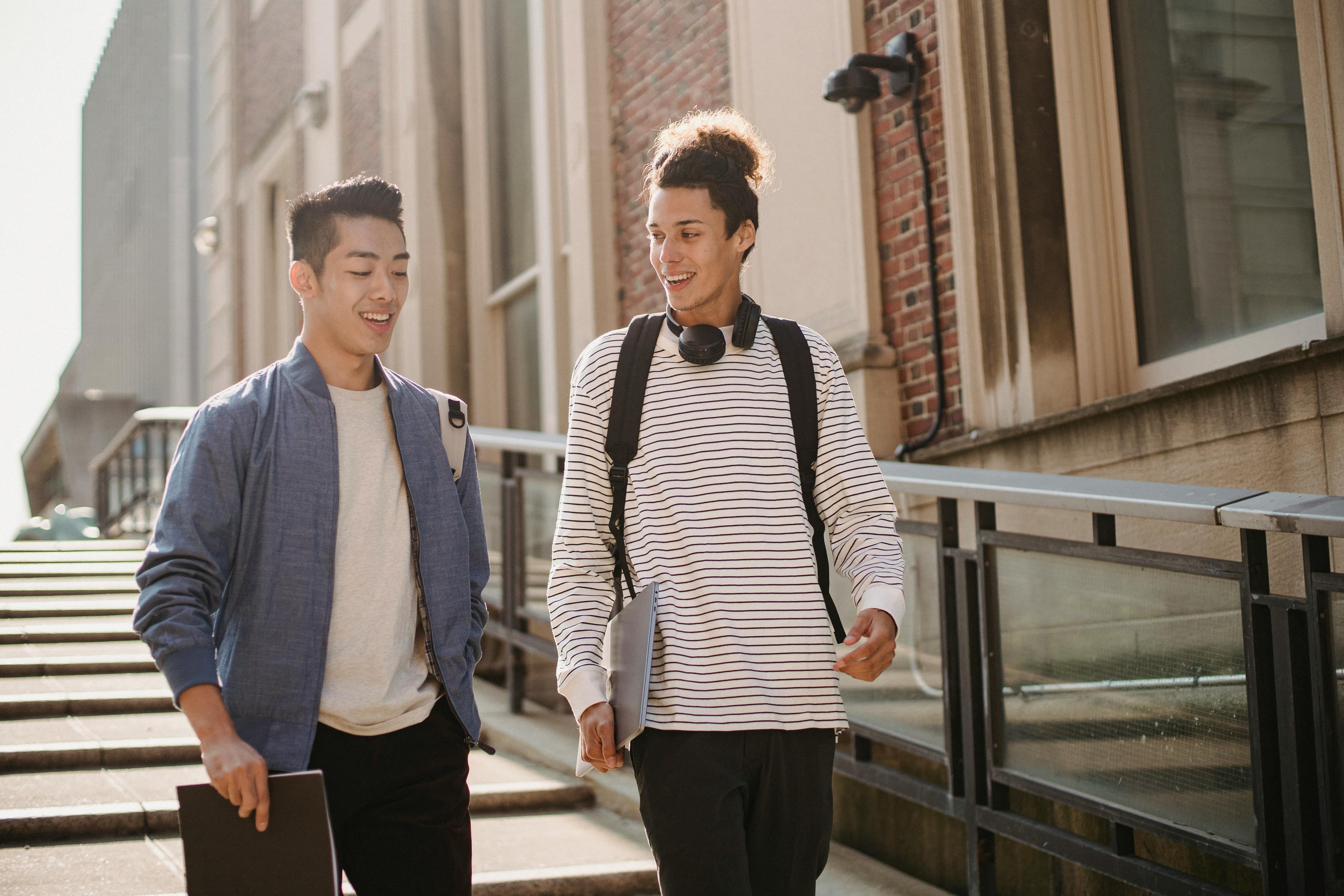 Two friends walking outdoors mid-conversation