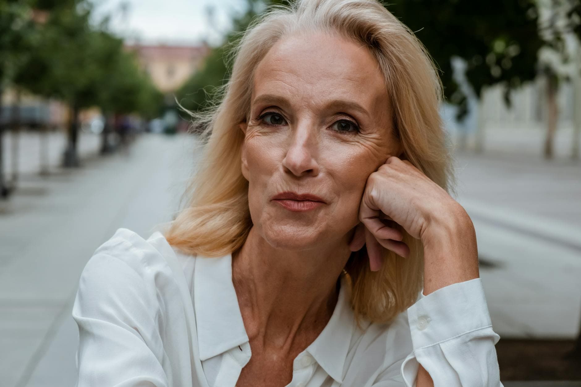 A confident woman in her forties photographed outdoors